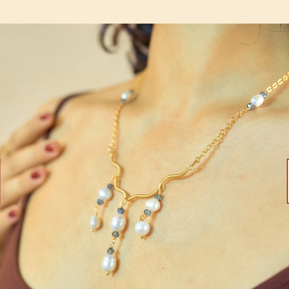 Gold and pearl necklace with blue stone accents